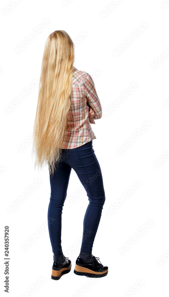 Fototapeta premium back view of standing young beautiful woman.