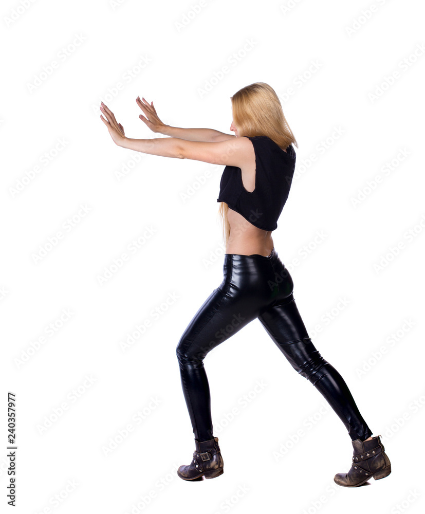 back view of woman pushes wall back view of woman pushes wall
