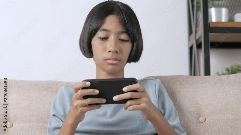 Asian girl are using a smartphone to play game. Asian girl are using a smartphone to play game.