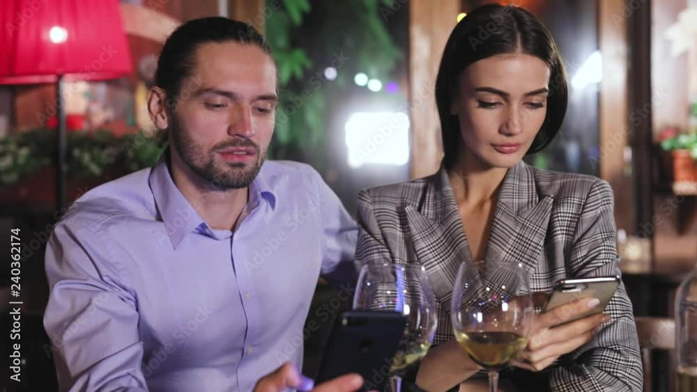 Communication Problem. People Using Phone On Date At Restaurant Communication Problem. People Using Phone On Date At Restaurant