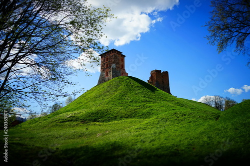 An old abandoned red brick castle on a hill