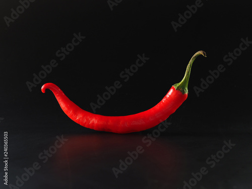 Red chili peppers on black background