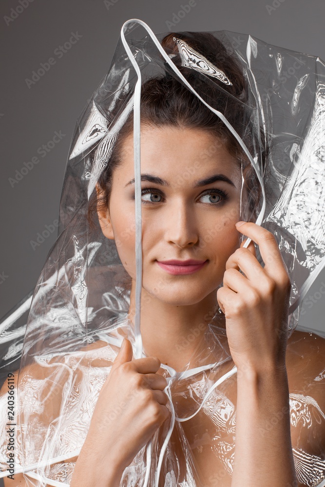 Beautiful woman in a transparent rain coat Stock Photo Adobe Stock