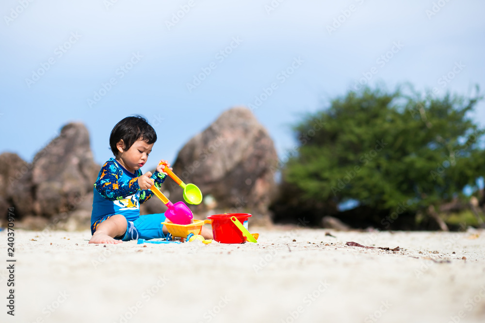 Little boy baby playing with sand on sea shore, Happy time on summer beach Little boy baby playing with sand on sea shore, Happy time on summer beach