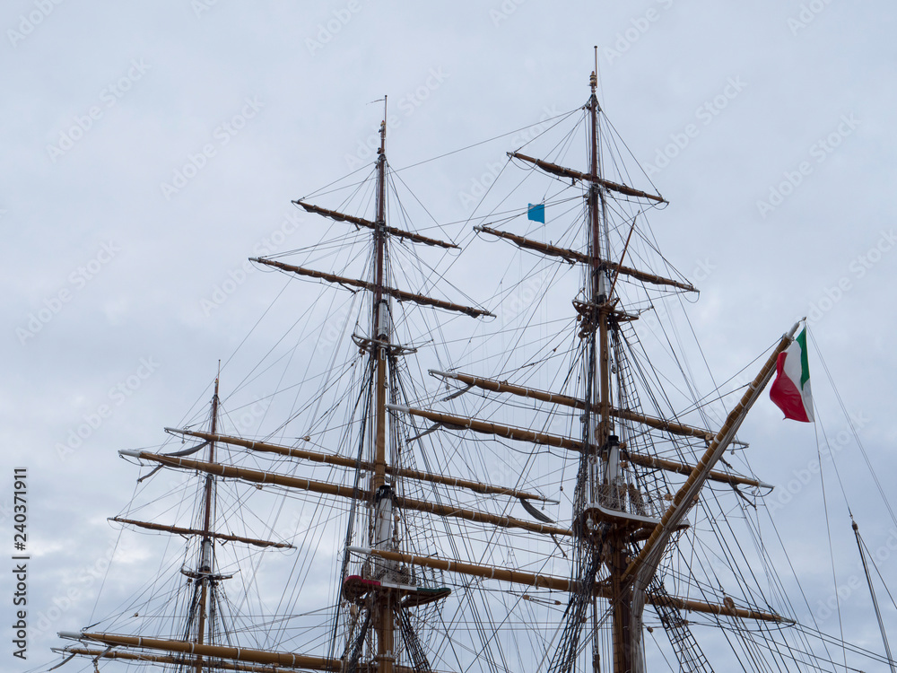 Masts and the rigging of ancient sailboat on nignt sky background. Exterior of old tall ship. Amerigo Vespucci - bow of ancient sailing vessel.