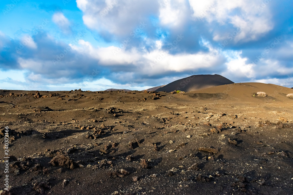 Beautiful mountain landscape with volcanoes at sunset in Timanfaya National Park in Lanzarote, Canary Islands, Spain