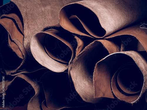 Stack of brown leather in workshop photo