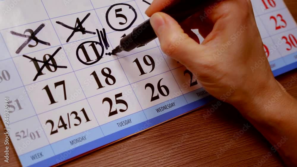 close up. calendar of the month women's hand felt pen highlights important days this week