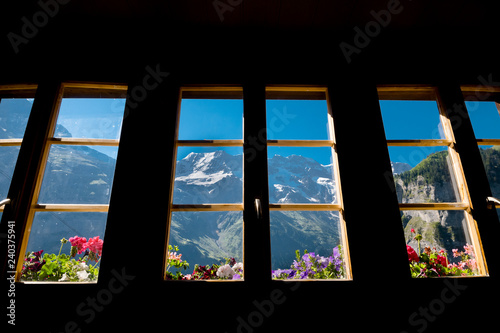 Alps in summer morning. Gimmelwald, Lauterbrunnen, Switzerland, Alps mountain landscape through the window. Europe Swiss.