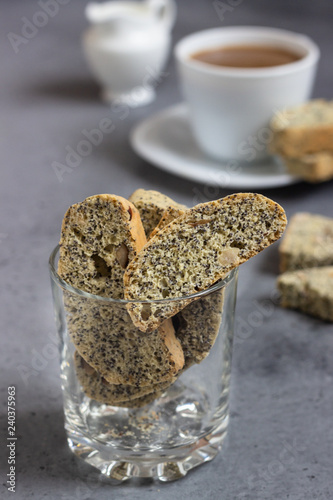 Biscotti or Cantuccini with hazelnuts and poppy seeds  and a cup of coffee. Traditional Italian double baked cookies.