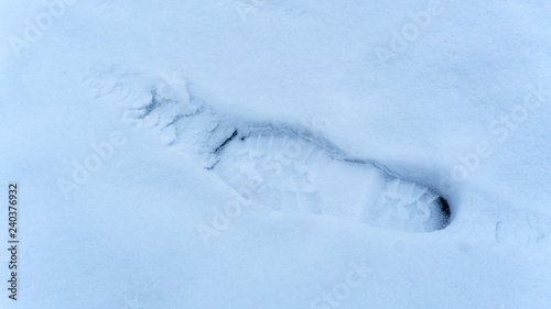 One footprint from a male boot in the snow