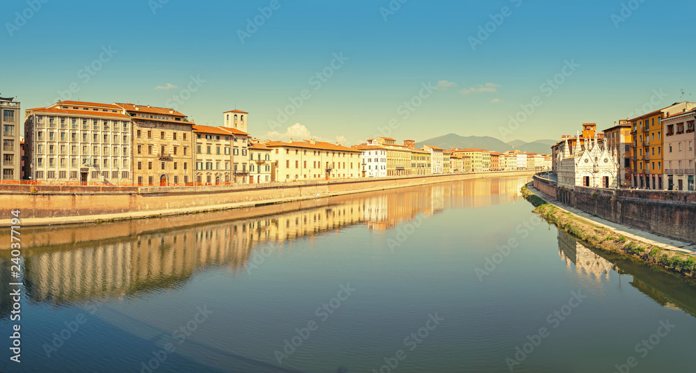 Wide panoramic view of the embankment of The Arno River in Pisa. Travel in Italy and Tuscany concept