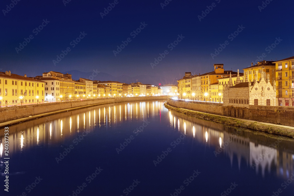 Night view of the Arno river in Pisa town, Italy