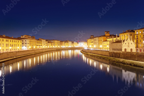 Night view of the Arno river in Pisa town, Italy