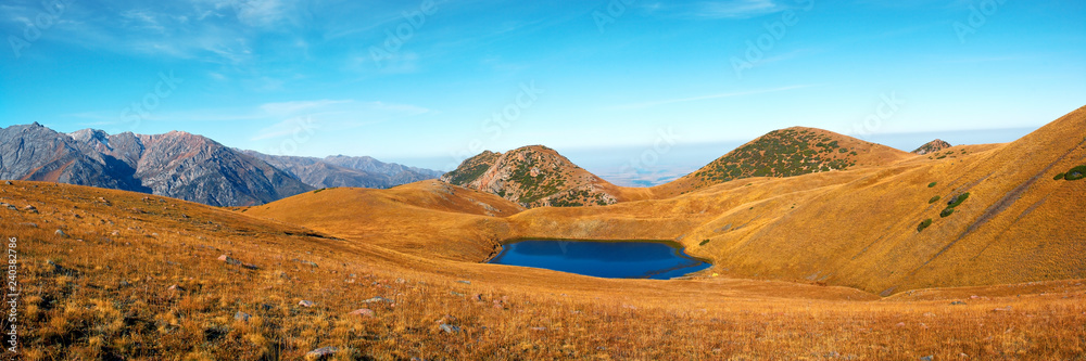 panorama of the lake high in the mountains in the fall at sunset