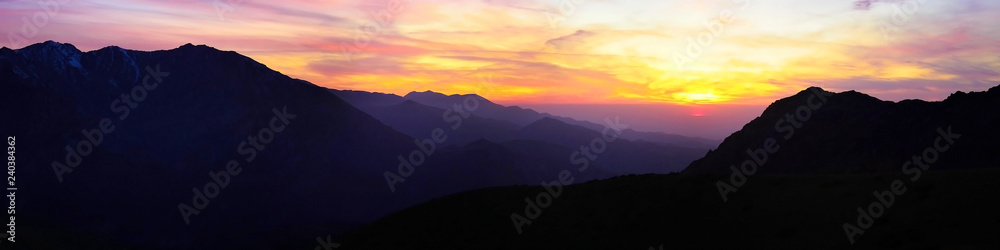 contrasting sunset high in the mountains panorama - obrazy, fototapety, plakaty 
