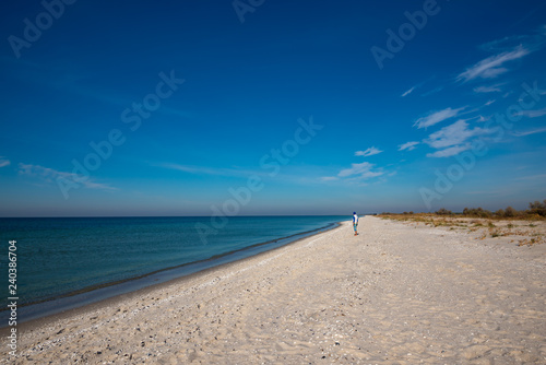 Traveler stands on the deserted beach