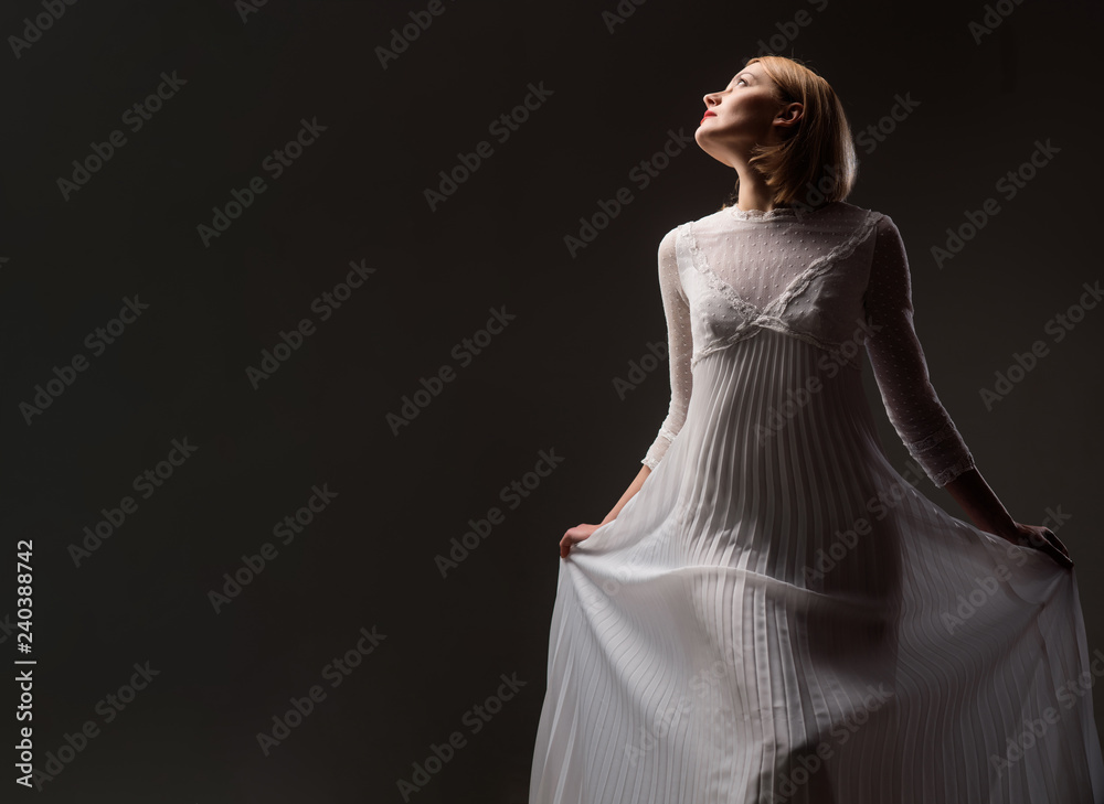 Fototapeta premium Sexy woman in lace white dress. Beautiful girl with blonde hair, perfect makeup. Girl in elegant white dress. Elegant dress concept. Retro blonde lady wearing fashionable white dress. Beauty, fashion.