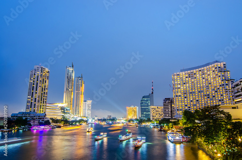Cityscape of boat light trails on Chao Phraya River night scene in Bangkok, Thailand. © TeTe Song