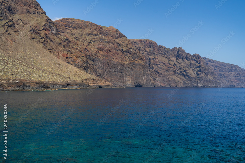 Vertical cliffs Acantilados de Los Gigantes (Cliffs of the Giants). View from Cape Teno (Punta de Teno). Tenerife. Canary Islands. Spain. Vertical cliffs Acantilados de Los Gigantes (Cliffs of the Giants). View from Cape Teno (Punta de Teno). Tenerife. Canary Islands. Spain.