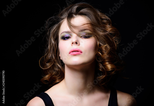 Beauty salon concept. Woman with curly hairstyle and makeup on black background. Makeup idea for elegant outfit. Professional makeup. Attractive elegant lady with smoky eyes makeup and pink lipstick