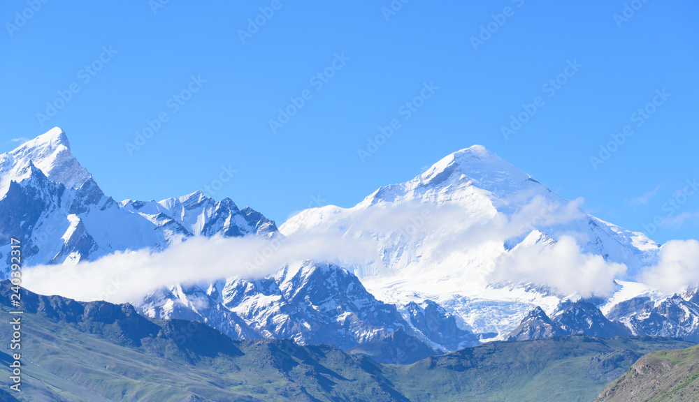 Jammu-Kashmir landscape with snow peaks and blue cloudy sky in background in India