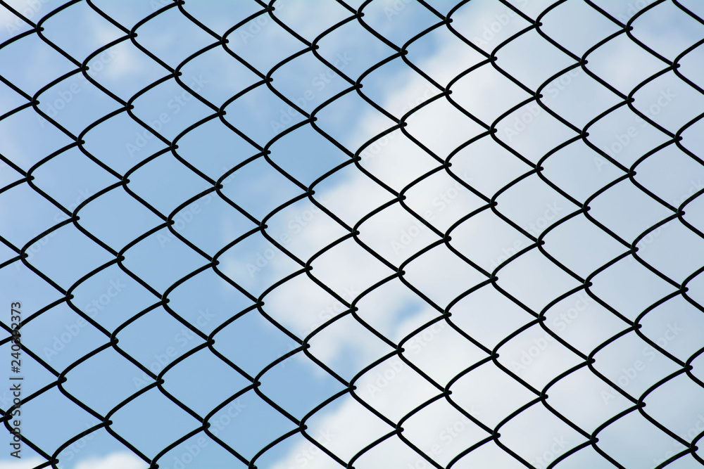 the cage metal net on blue sky background - pattern style the cage metal net on blue sky background - pattern style