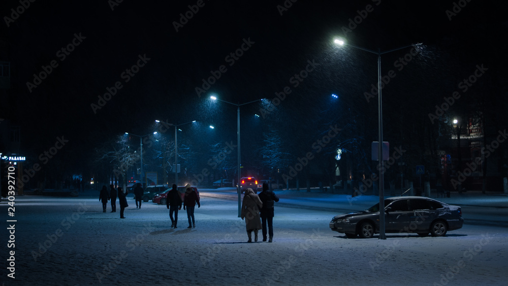 people walking in city at  winter night