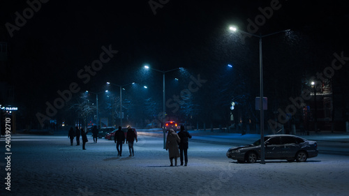 people walking in city at  winter night © Анна Бугаёва