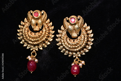Fancy golden earrings for woman fashion closeup macro image