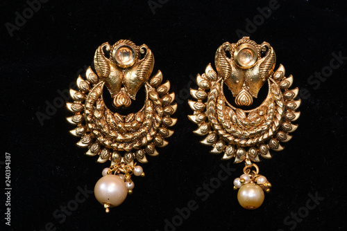 Fancy golden earrings for woman fashion closeup macro image
