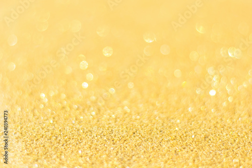 Defocused gold glitter background. Gold abstract bokeh background. Christmas abstract background