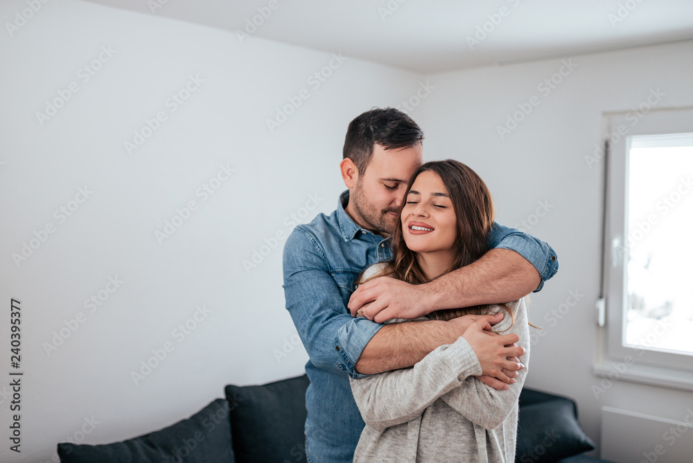 Fototapeta premium Affectionate couple hugging at home.