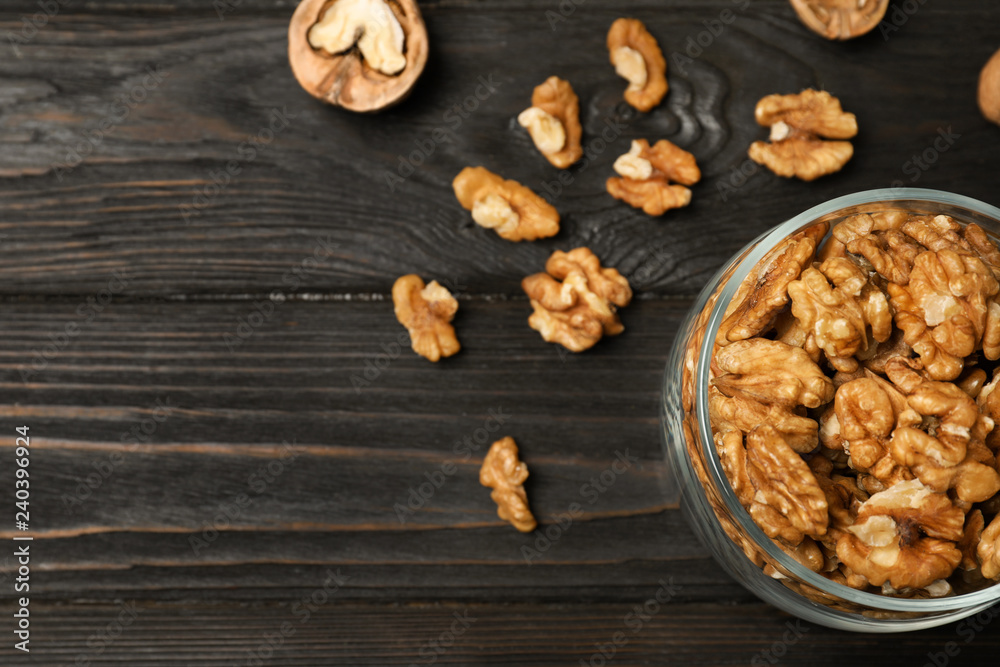 Obraz premium Flat lay composition with walnuts and space for text on wooden background