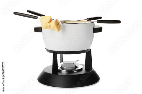 Pot of delicious cheese fondue and forks with bread on white background