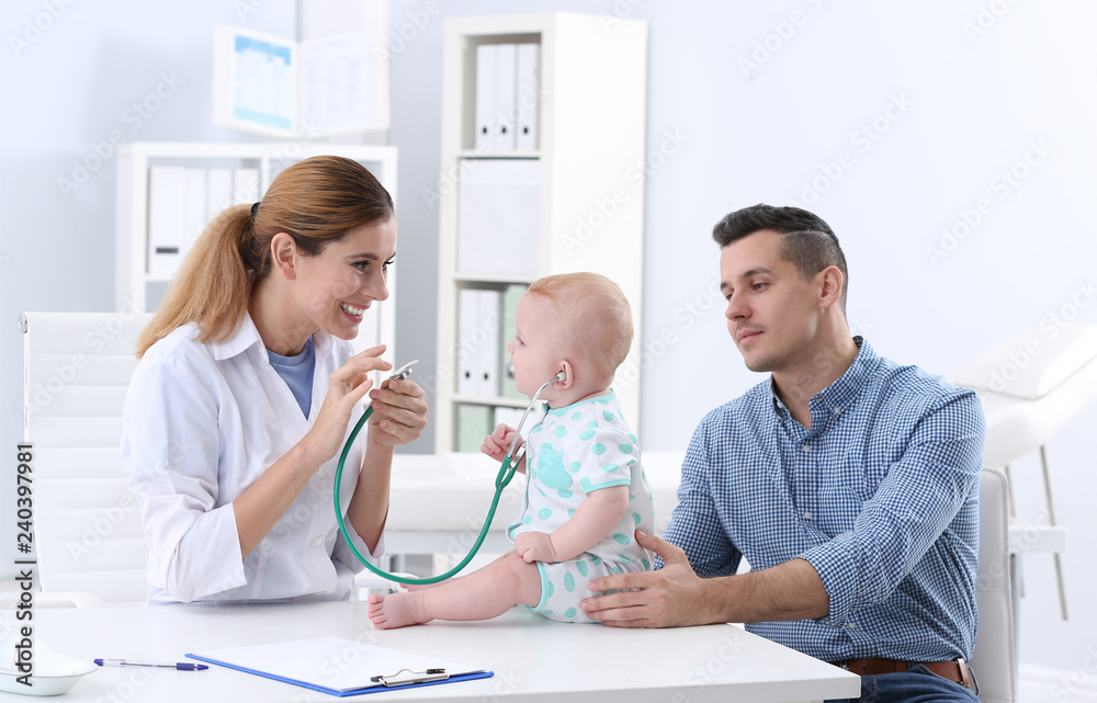 Fototapeta premium Man with his baby visiting children's doctor in hospital