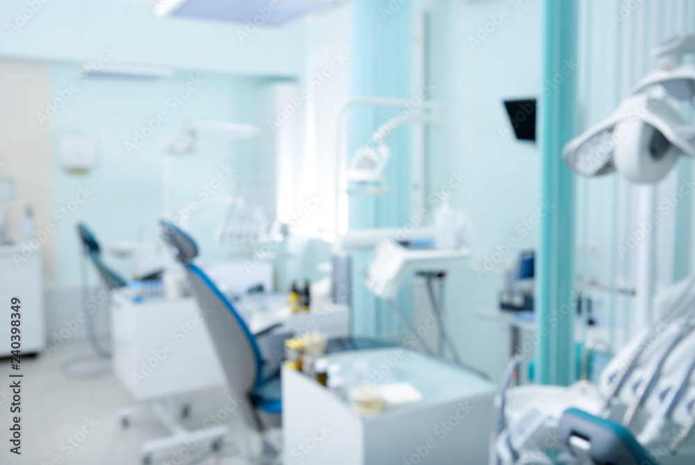 Blurred view of dentist office with chairs and professional equipment Blurred view of dentist office with chairs and professional equipment