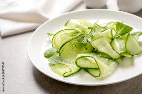 Plate with delicious cucumber salad on table, closeup