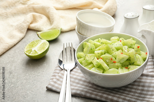 Delicious cucumber salad in bowl served on table. Space for text