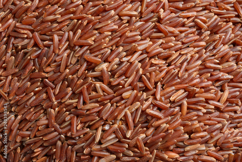Raw brown rice as background, closeup view Raw brown rice as background, closeup view