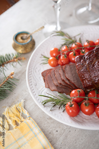 Sliced roast beef with cherry tomatoes and mustard sauce