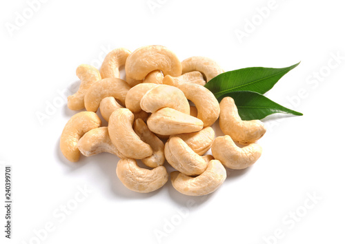 Tasty cashew nuts with leaves isolated on white