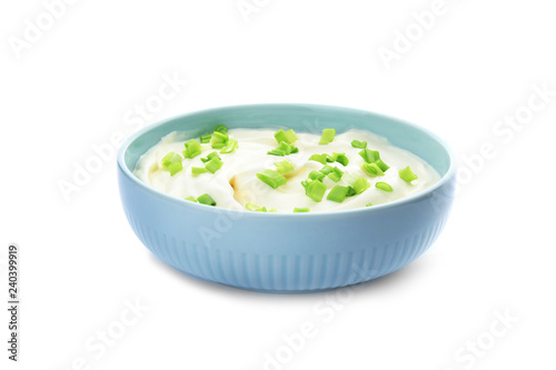 Bowl with sour cream and herbs on white background