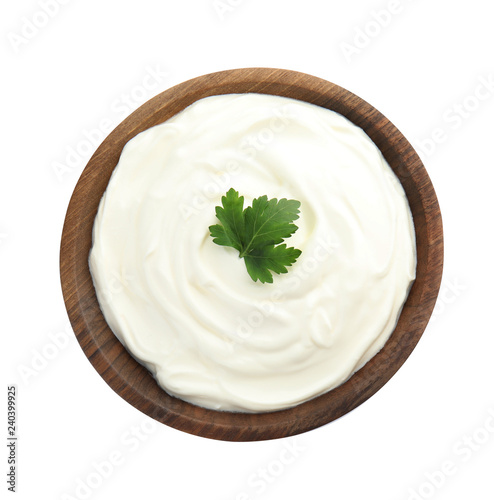 Bowl with sour cream and herbs on white background, top view