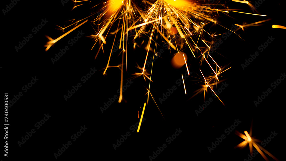 Fototapeta premium Christmas sparkler isolated on black background. Bengal fire