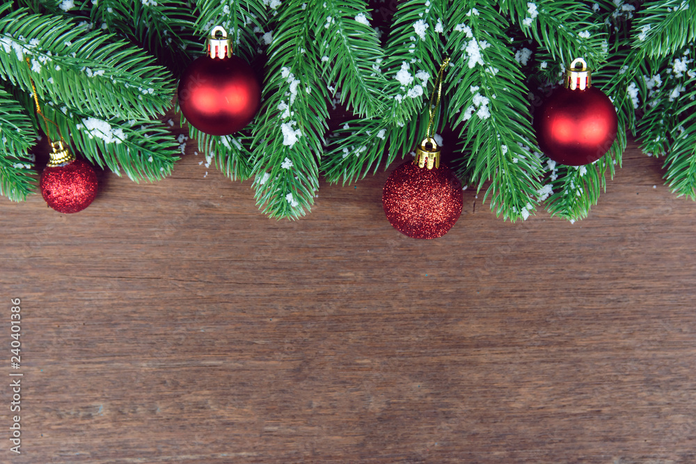 Christmas background. Fir tree branches, red Christmas ball and pine cones with snow decoration on a wooden board. with copy space for text. Christmas background. Fir tree branches, red Christmas ball and pine cones with snow decoration on a wooden board. with copy space for text.