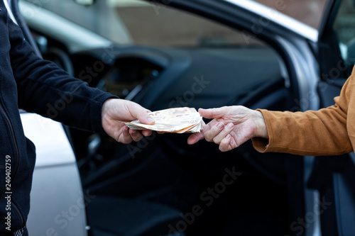 A man pays the car to an old lady