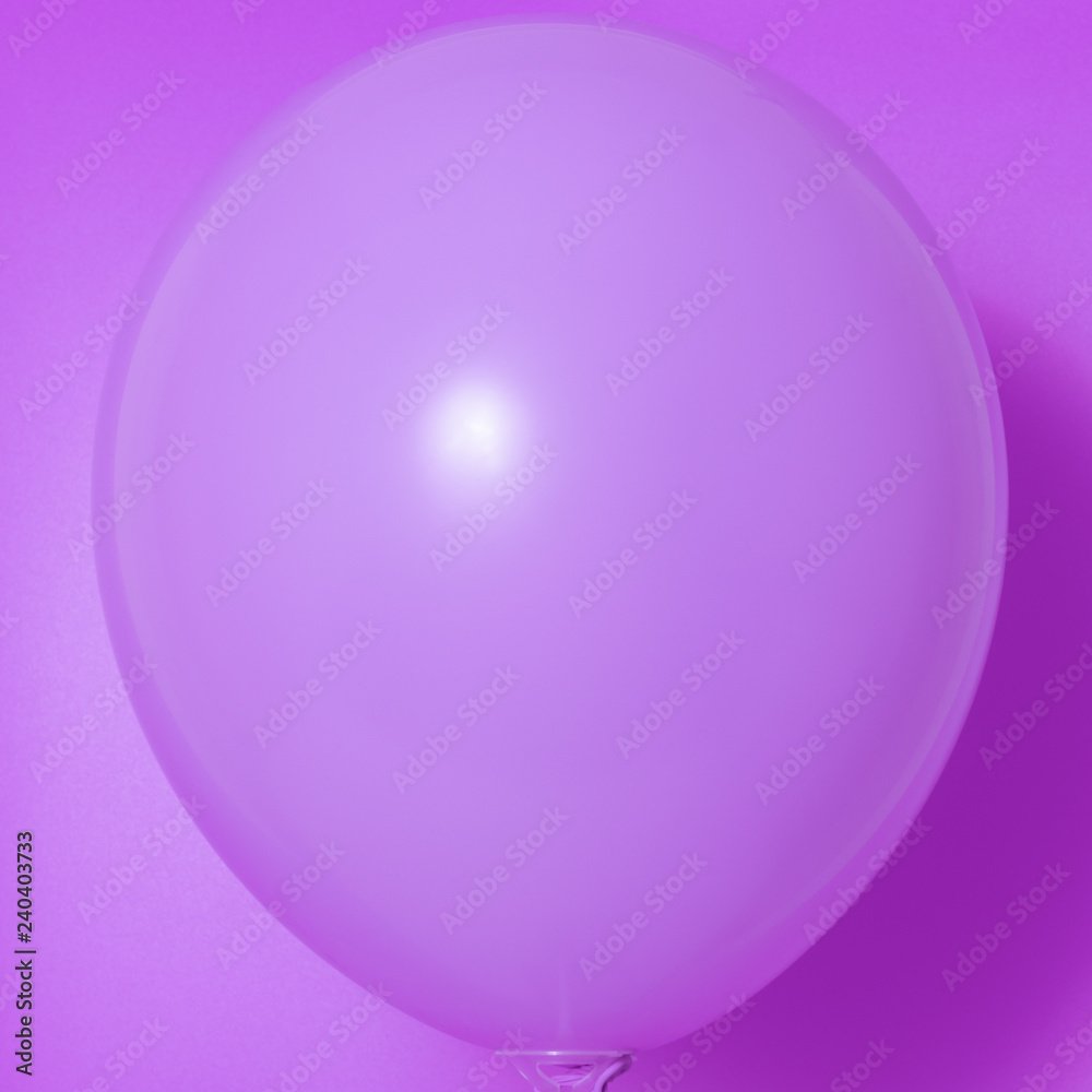 Purple balloon on a purple background with shadow. Side glare. Purple balloon on a purple background with shadow. Side glare.