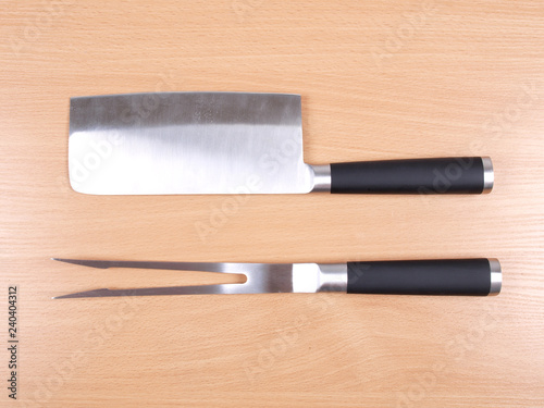 Metal kitchen knife on wooden background