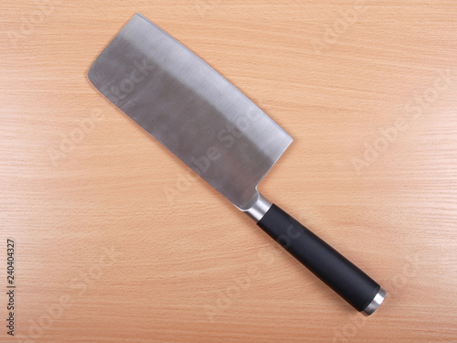Metal kitchen knife on wooden background
